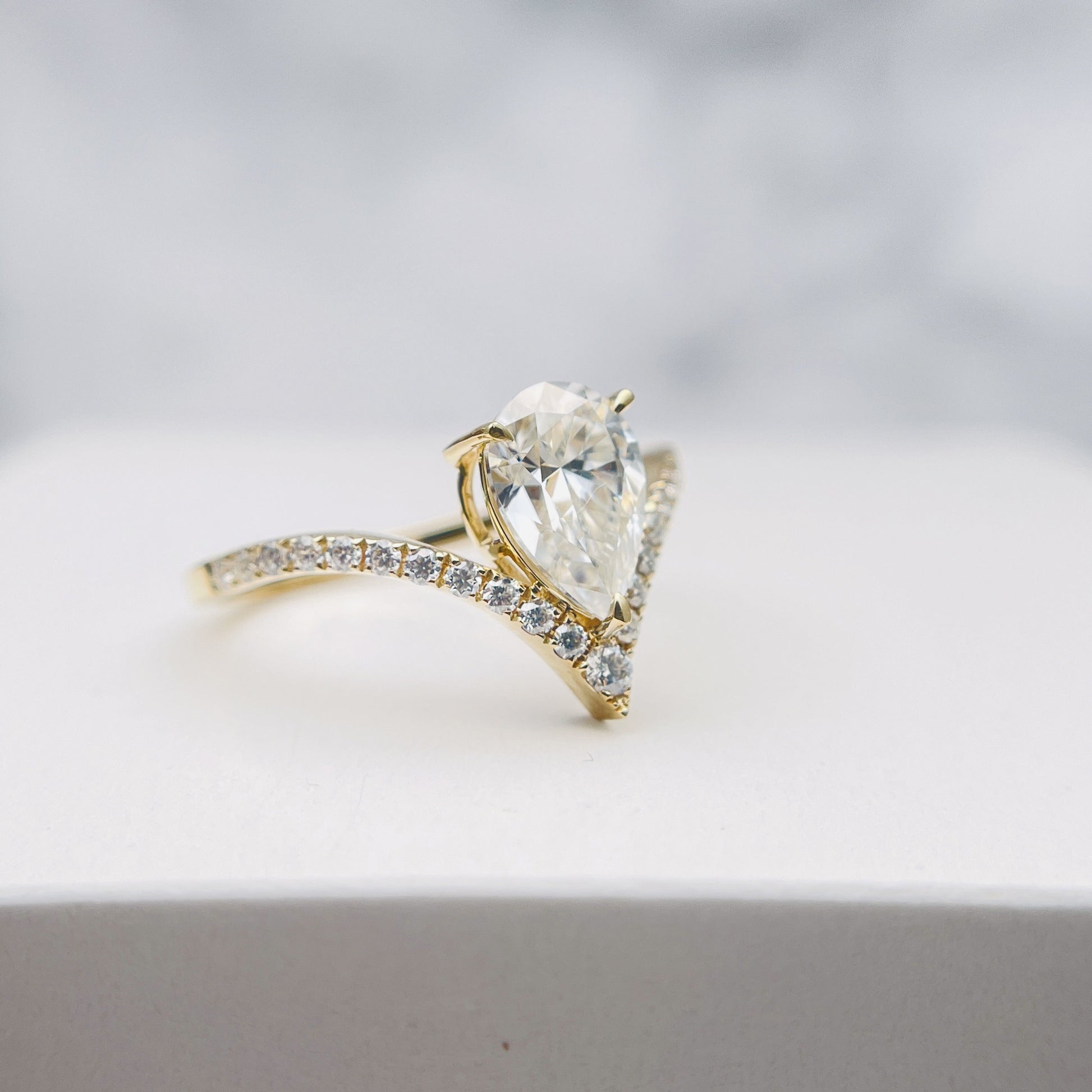 Pear Moissanite Ring in Silver and Gold